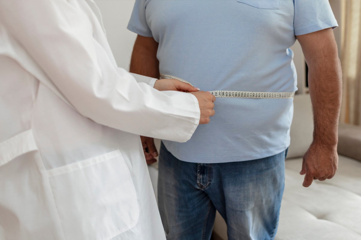 Doctor measuring patient's waist
